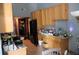 Kitchen with wooden cabinetry, tile flooring, and appliances at 14057 Ithaca Way, Orlando, FL 32826