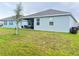Spacious backyard featuring a covered patio with dining set and well-kept lawn at 1412 Brentwood Dr, Kissimmee, FL 34746