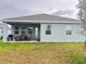 A cozy covered patio with an outdoor dining set, perfect for relaxing and entertaining at 1412 Brentwood Dr, Kissimmee, FL 34746