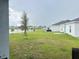 Grassy backyard overlooking a serene lake at 1412 Brentwood Dr, Kissimmee, FL 34746