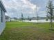 Expansive backyard overlooking a serene lake, with a green lawn and walking path at 1412 Brentwood Dr, Kissimmee, FL 34746