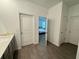 Bathroom featuring a single sink vanity and tile flooring, leading to the main bedroom at 1412 Brentwood Dr, Kissimmee, FL 34746