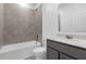 Bathroom featuring a tub with tile surround, toilet, and vanity at 1412 Brentwood Dr, Kissimmee, FL 34746