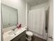 Well-lit bathroom with single vanity and shower-tub combo for relaxation at 1412 Brentwood Dr, Kissimmee, FL 34746