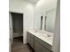 Bathroom features a double vanity with white countertops and gray cabinets at 1412 Brentwood Dr, Kissimmee, FL 34746