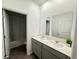 Bathroom features a double vanity with white countertops and gray cabinets at 1412 Brentwood Dr, Kissimmee, FL 34746