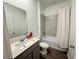 Modern bathroom with gray vanity, white countertop, large mirror, and a shower/tub combo with neutral tile at 1412 Brentwood Dr, Kissimmee, FL 34746