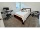 Bedroom with a bed, bedside table, keyboard, a window providing natural light, and soft gray carpet flooring at 1412 Brentwood Dr, Kissimmee, FL 34746
