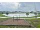 A community park with exercise equipment and a tranquil lake view, perfect for outdoor activities at 1412 Brentwood Dr, Kissimmee, FL 34746