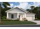 Charming single-story home featuring manicured lawn, stone accents and a two car garage at 1412 Brentwood Dr, Kissimmee, FL 34746
