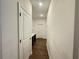 Long hallway with doors leading to various rooms, featuring stylish tile flooring at 1412 Brentwood Dr, Kissimmee, FL 34746