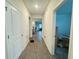 Hallway view showcasing seamless flow into kitchen and bedroom with wood-look tile floors at 1412 Brentwood Dr, Kissimmee, FL 34746