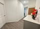 Neutral hallway featuring wood-look tile flooring and access to multiple rooms at 1412 Brentwood Dr, Kissimmee, FL 34746