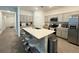 Modern kitchen featuring gray cabinets, stainless steel appliances, a large island with bar stool seating at 1412 Brentwood Dr, Kissimmee, FL 34746