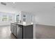 Kitchen featuring island, stainless steel dishwasher, and multiple windows bringing natural light at 1412 Brentwood Dr, Kissimmee, FL 34746