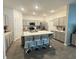 Spacious kitchen with gray cabinets, stainless steel appliances, a large island, and bar stool seating at 1412 Brentwood Dr, Kissimmee, FL 34746