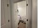 Functional laundry room with a washing machine and some shelving at 1412 Brentwood Dr, Kissimmee, FL 34746