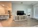 Bright open-concept living room boasts a TV and modern entertainment center, flowing into the eat-in kitchen at 1412 Brentwood Dr, Kissimmee, FL 34746