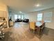 Open-concept living and dining area with tile flooring, comfortable sofas, dining table, and abundant natural light at 1412 Brentwood Dr, Kissimmee, FL 34746
