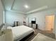Spacious main bedroom with tray ceiling, carpeted floors, and a view of the hallway at 1412 Brentwood Dr, Kissimmee, FL 34746
