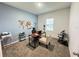Well-lit home office with a world map and two different style chairs at 1412 Brentwood Dr, Kissimmee, FL 34746