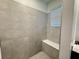 Stand-up shower featuring white tile and a window at 1412 Brentwood Dr, Kissimmee, FL 34746