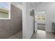 Shower with tiled walls next to a window; open door to sunlit room at 1412 Brentwood Dr, Kissimmee, FL 34746