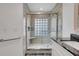 Modern bathroom featuring granite countertop, glass shower with seat, and neutral tile at 1517 Abberton Dr, Orlando, FL 32837