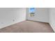 Bedroom featuring neutral carpeting and a window overlooking the yard at 1517 Abberton Dr, Orlando, FL 32837