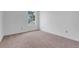 Bedroom with neutral carpeting and a window overlooking a neighboring house at 1517 Abberton Dr, Orlando, FL 32837