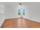 Bedroom with laminate floors, ceiling fan and two windows with natural light at 1517 Abberton Dr, Orlando, FL 32837