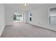 Neutral carpeted bedroom with sliding door to sunroom and large window at 1517 Abberton Dr, Orlando, FL 32837