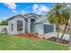 Inviting two-story home with mature landscaping, a blue exterior, and an attached two-car garage at 1517 Abberton Dr, Orlando, FL 32837