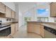 Sunlit kitchen featuring granite countertops and tile flooring, flowing into a dining area at 1517 Abberton Dr, Orlando, FL 32837