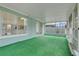 Spacious sunroom featuring bright green carpet and many windows at 1517 Abberton Dr, Orlando, FL 32837