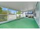 Bright sunroom with green carpet and multiple windows for natural light at 1517 Abberton Dr, Orlando, FL 32837