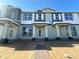 Brand new townhouse with covered entrance and brick walkway, still under construction at 15310 Burgtheater Dr, Winter Garden, FL 34787