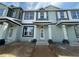 Newly constructed townhouse with a covered entrance, awaiting landscaping at 15310 Burgtheater Dr, Winter Garden, FL 34787