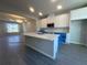 Bright kitchen with white cabinetry, center island, and modern appliances, new construction at 15310 Burgtheater Dr, Winter Garden, FL 34787