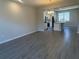 Open-concept living space with wood-look tile flooring, perfect for entertaining at 15310 Burgtheater Dr, Winter Garden, FL 34787