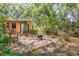 Tranquil backyard patio with a wooden bench, perfect for outdoor relaxation at 1860 Ne 62Nd St, Ocala, FL 34479
