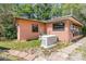 Home's backyard features a generator, brick paver path and a small garden at 1860 Ne 62Nd St, Ocala, FL 34479
