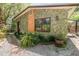 Exterior elevation showing stone facade, window, and lush landscaping at 1860 Ne 62Nd St, Ocala, FL 34479