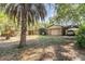 Property view showing main house, outbuildings, carports, and other structures at 1860 Ne 62Nd St, Ocala, FL 34479