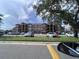 Exterior of residential apartment buildings with neat landscaping, street parking, and designated parking at 2202 Key West Ct # 633, Kissimmee, FL 34741