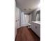 Bathroom features a shower-tub combo with neutral gray walls, white vanity, and wood-look flooring at 2202 Key West Ct # 633, Kissimmee, FL 34741