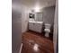 Bathroom with sleek wood floors, vanity with a sink, toilet, and modern mirror at 2202 Key West Ct # 633, Kissimmee, FL 34741
