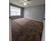 Spacious bedroom with neutral walls, a ceiling fan, a window, and carpet flooring at 2202 Key West Ct # 633, Kissimmee, FL 34741