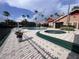 Relax in the community pool area with palm trees, lounge chairs, and a charming clubhouse, perfect for outdoor enjoyment at 2202 Key West Ct # 633, Kissimmee, FL 34741