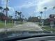 Community entrance with automatic gate, mature palms, lush landscaping, and several residential buildings at 2202 Key West Ct # 633, Kissimmee, FL 34741
